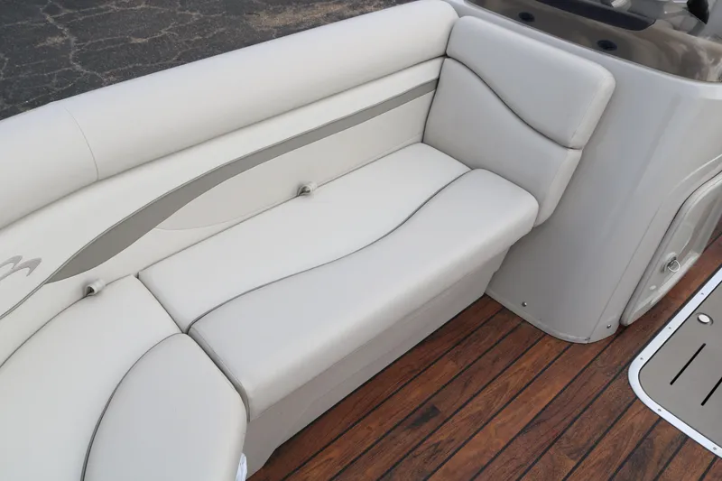 Slide: The Image of 2015 Bennington 22SSLDX boat interior with beige seating and wooden deck. - 20