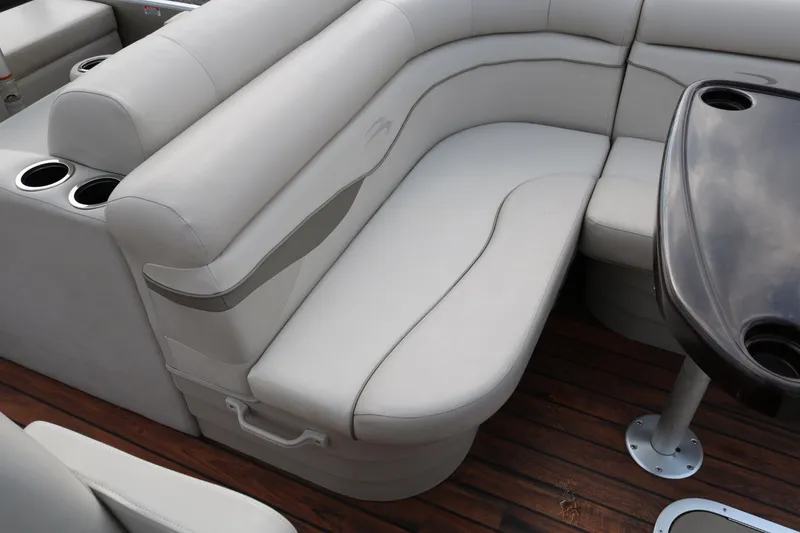 Slide: The Image of Luxurious seating on 2015 Bennington 22SSLDX boat with wooden deck and cup holders. - 25