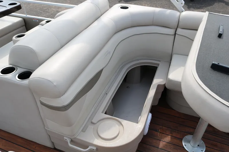 Slide: The Image of 2015 Bennington 22SSLDX boat interior with storage compartment and seating. - 26