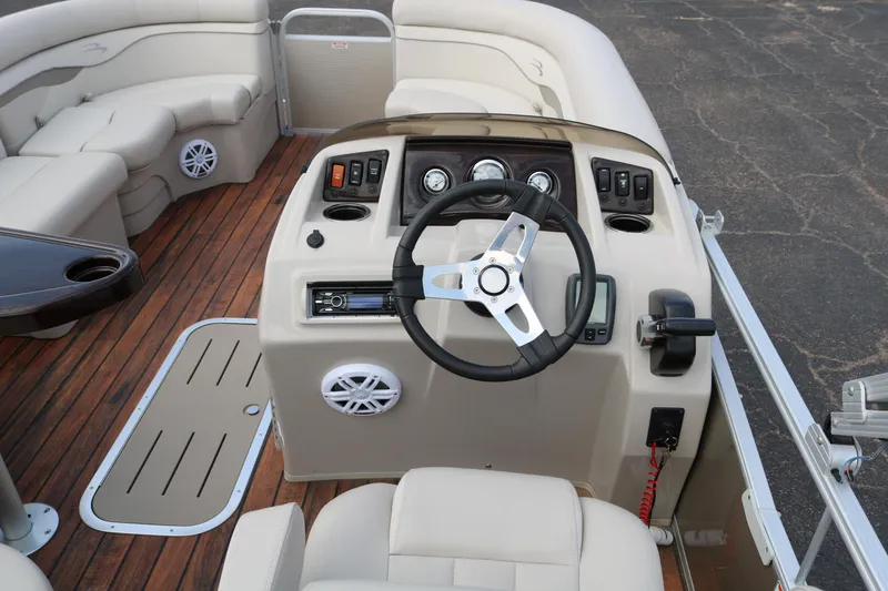 Slide: The Image of 2015 Bennington 22SSLDX boat interior with steering wheel and dashboard controls. - 28