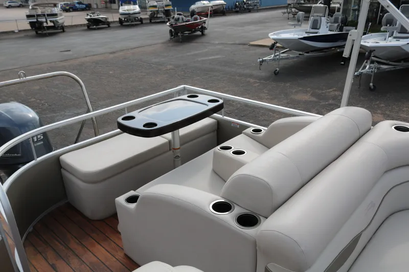 Slide: The Image of 2015 Bennington 22SSLDX pontoon boat interior with seating and table. - 29