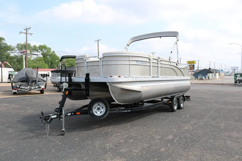 Slide: The Image of 2015 Bennington 22SSLDX pontoon boat on trailer in parking lot. - 3