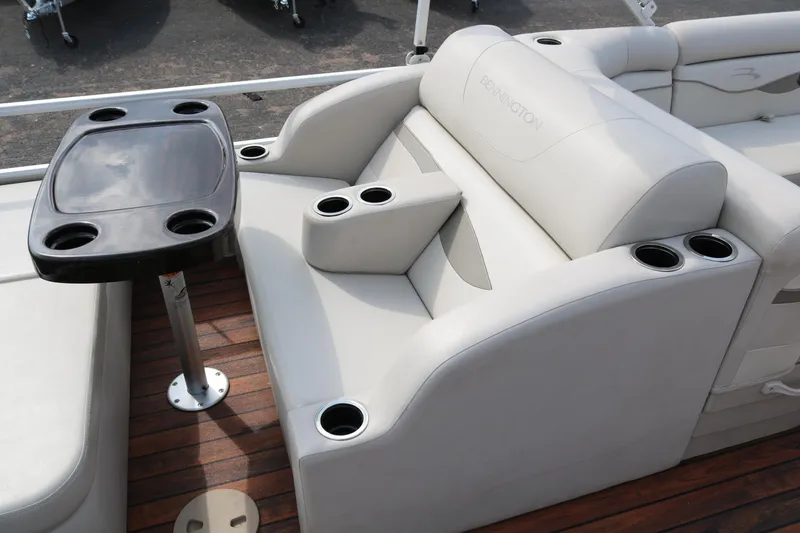 Slide: The Image of 2015 Bennington 22SSLDX boat interior with cushioned seating and cup holders. - 30