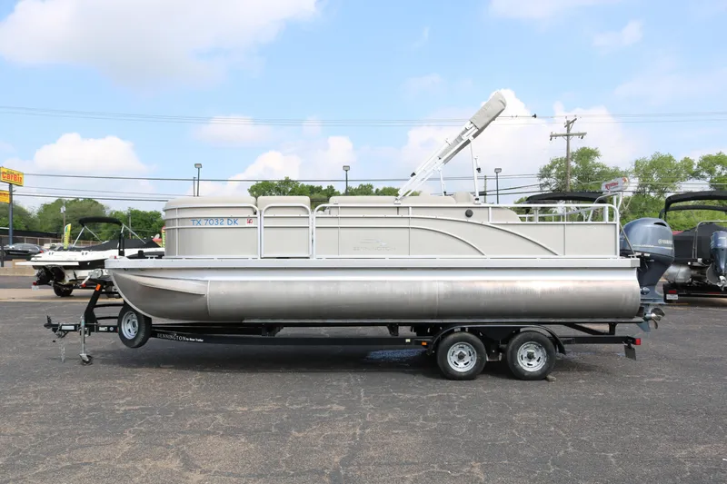 Slide: The Image of 2015 Bennington 22SSLDX pontoon boat on a trailer, parked outdoors. - 4