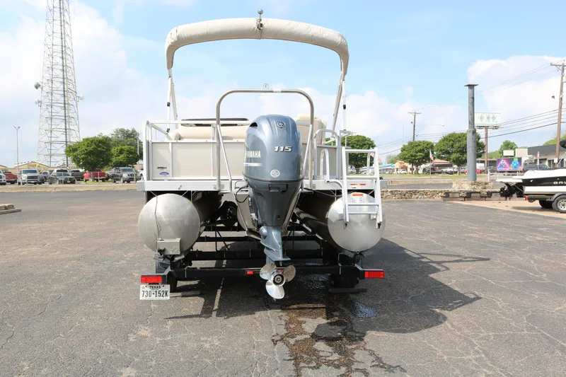Slide: The Image of 2015 Bennington 22SSLDX pontoon boat with Yamaha outboard motor, parked on asphalt. - 6