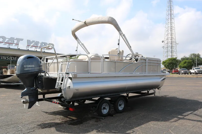 Slide: The Image of 2015 Bennington 22SSLDX pontoon boat on trailer at boat yard. - 7