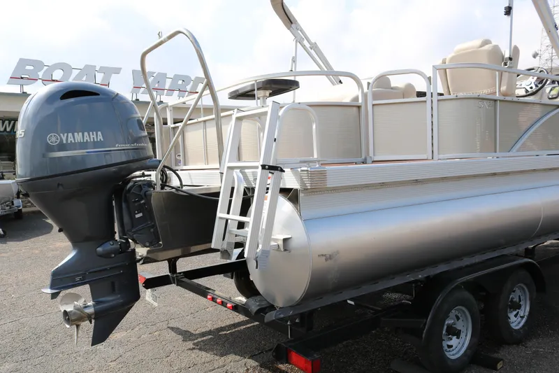 Slide: The Image of 2015 Bennington 22SSLDX pontoon boat with Yamaha outboard motor on trailer. - 8