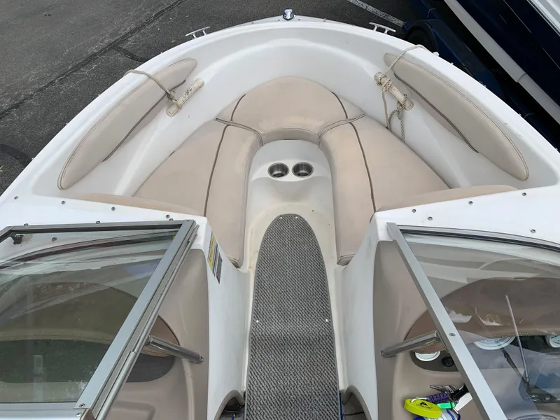 Slide: The Image of 2001 Maxum 1800 SR boat interior with beige seating and cup holders. - 2