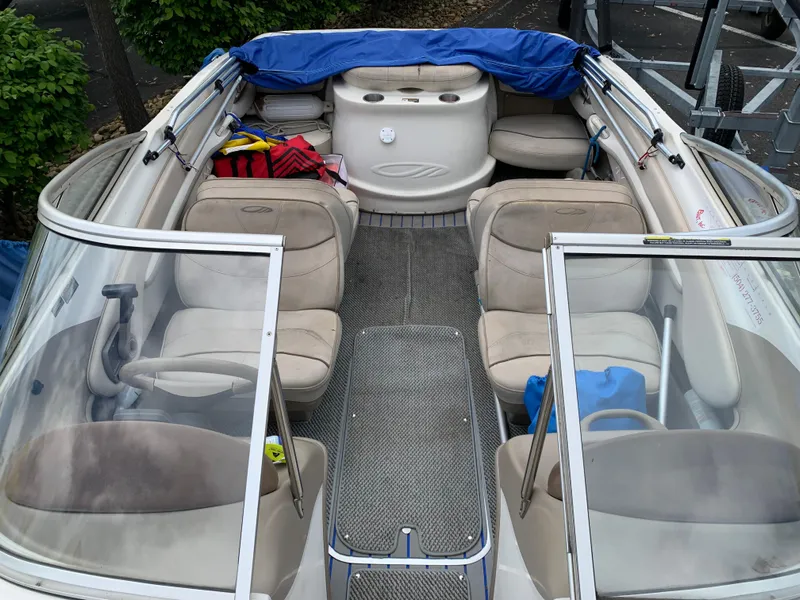 Slide: The Image of 2001 Maxum 1800 SR boat interior with beige seating and blue cover. - 3