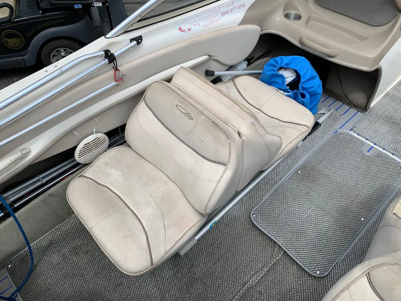 Slide: The Image of 2001 Maxum 1800 SR boat interior with beige seating and carpeted flooring. - 4