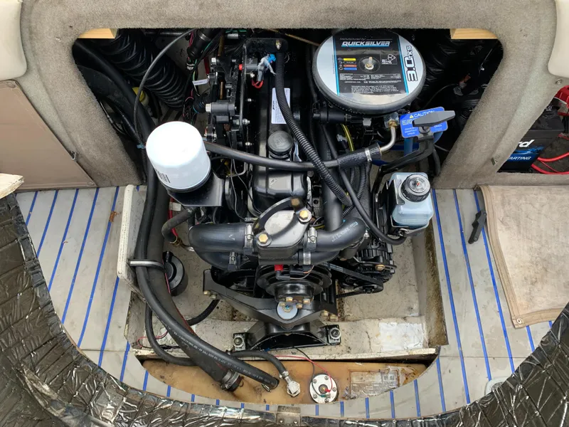 Slide: The Image of Engine compartment of a 2001 Maxum 1800 SR boat, showcasing detailed mechanical components. - 8