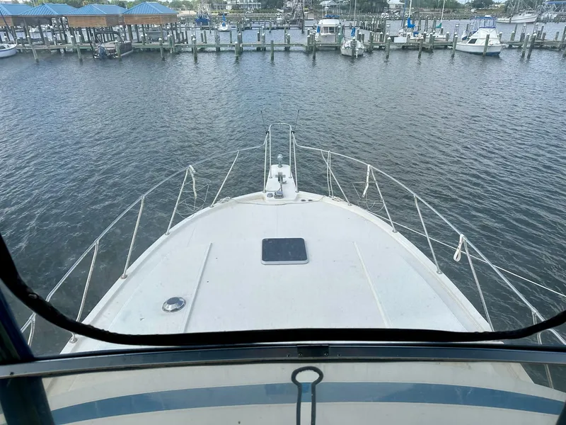 Slide: The Image of 1986 Chris-Craft Yacht Fisherman docked at marina, viewed from helm. - 15