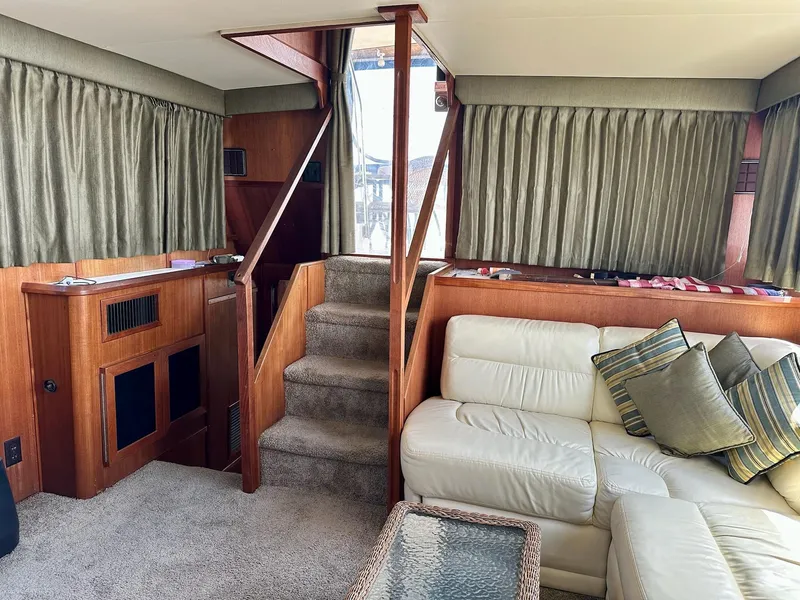 Slide: The Image of Interior of 1986 Chris-Craft Yacht Fisherman with white leather seating and wooden accents. - 19