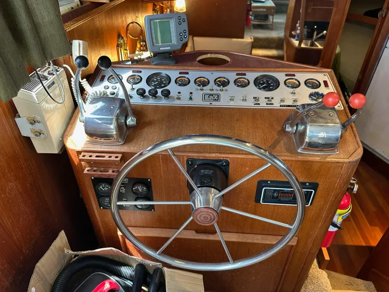 Slide: The Image of 1986 Chris-Craft Yacht Fisherman helm with steering wheel and control panel. - 20