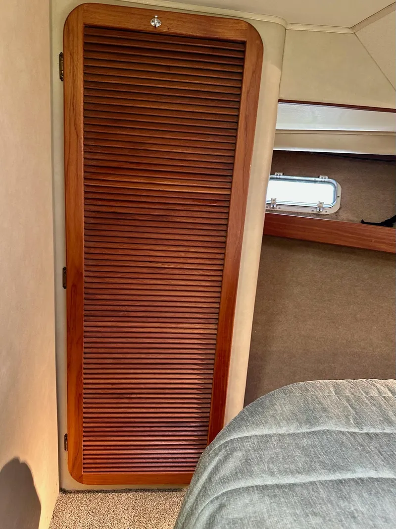 Slide: The Image of 1986 Chris-Craft Yacht Fisherman interior with wooden louvered door and window. - 33