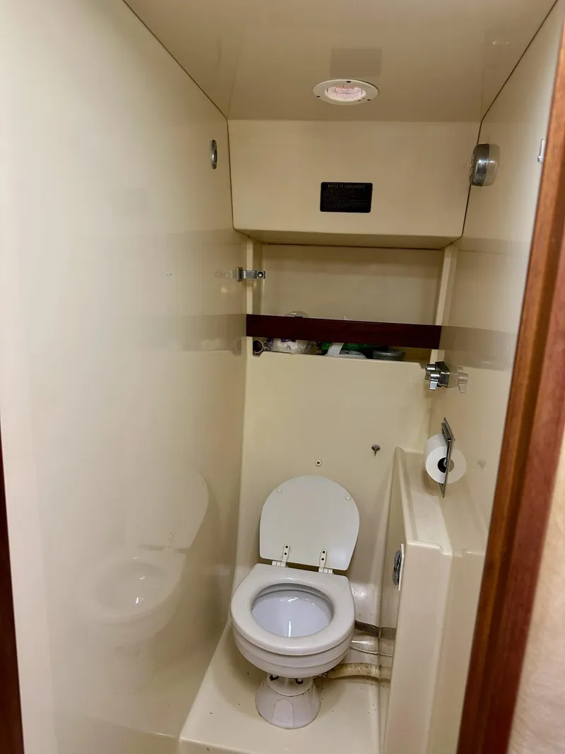 Slide: The Image of 1986 Chris-Craft Yacht Fisherman bathroom with toilet and compact design. - 34