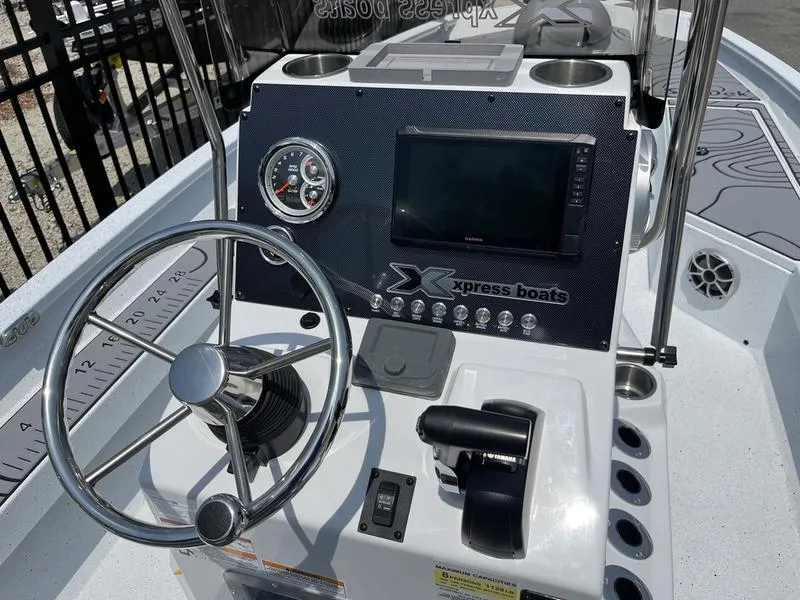 Slide: The Image of 2025 Xpress H22B boat dashboard with steering wheel and control panel. - 12
