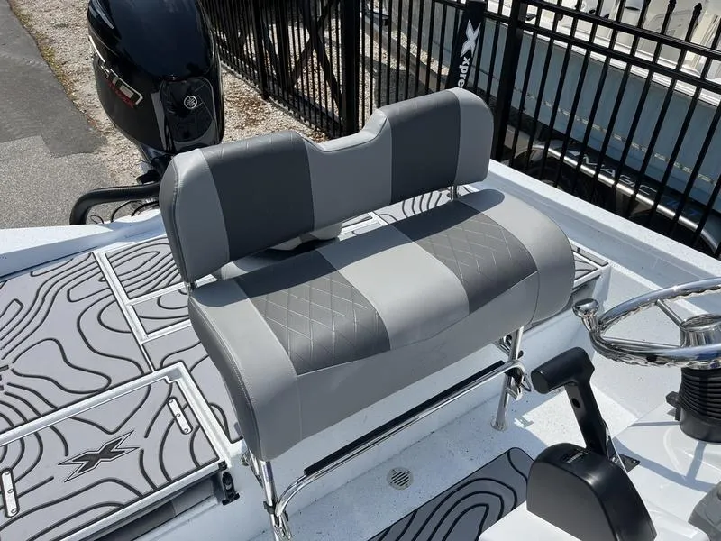 Slide: The Image of 2025 Xpress H22B boat with gray seating and steering wheel, featuring modern design elements. - 14