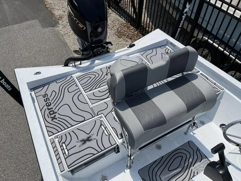 Slide: The Image of 2025 Xpress H22B boat with gray seating and patterned deck design. - 15
