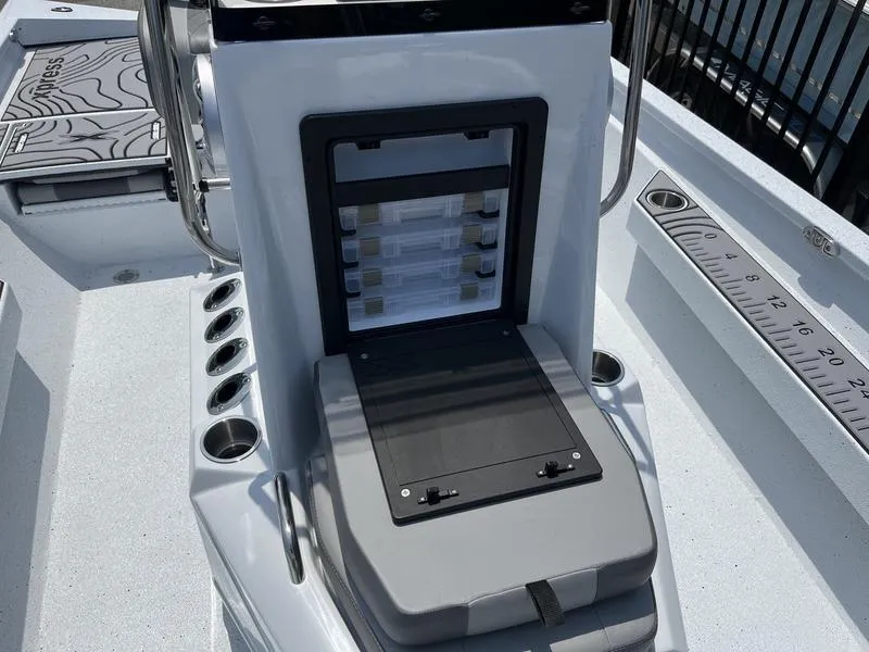 Slide: The Image of 2025 Xpress H22B boat console with storage compartments and measuring ruler. - 9