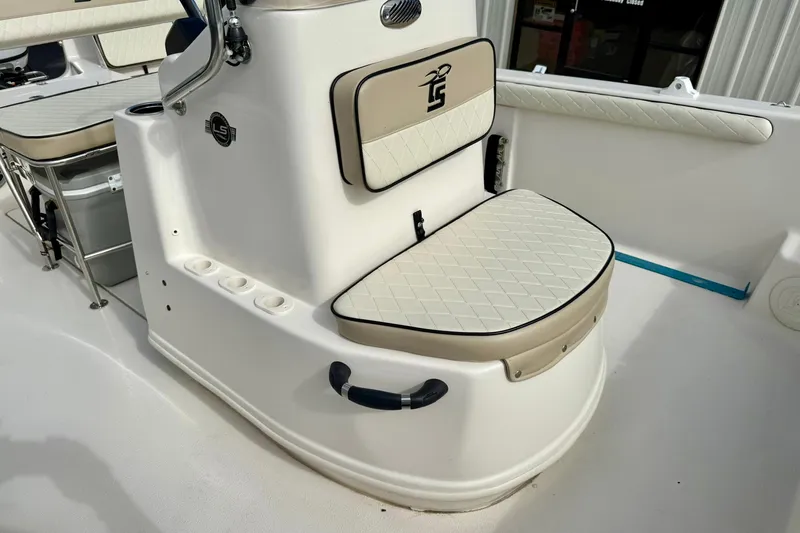 Slide: The Image of 2024 Carolina Skiff 19 LS boat interior with cushioned seating and storage. - 17