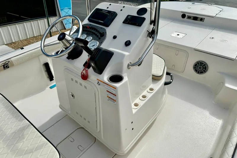 Slide: The Image of 2024 Carolina Skiff 19 LS boat console with steering wheel and control panel. - 19