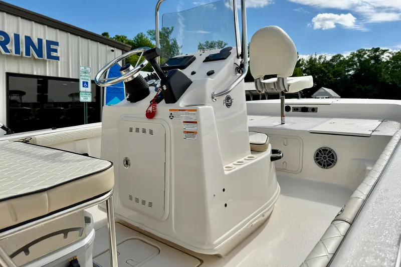Slide: The Image of 2024 Carolina Skiff 19 LS boat interior with steering console and seating, outdoors. - 20