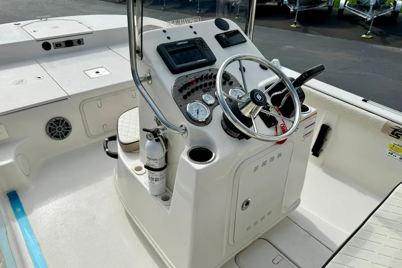 Slide: The Image of 2024 Carolina Skiff 19 LS boat console with steering wheel and gauges. - 21