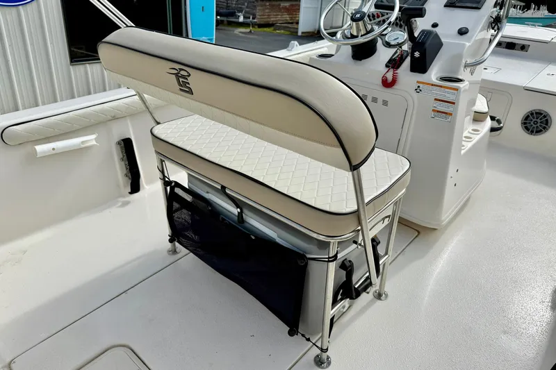 Slide: The Image of 2024 Carolina Skiff 19 LS boat interior with cushioned seating and steering console. - 25