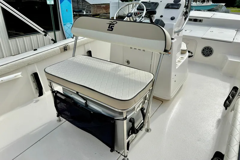 Slide: The Image of 2024 Carolina Skiff 19 LS boat interior with cushioned seating and steering console. - 26