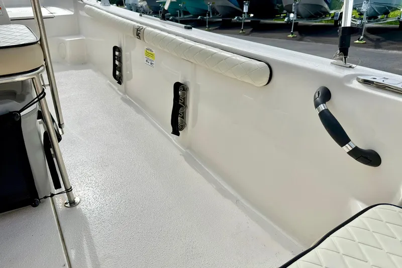 Slide: The Image of 2024 Carolina Skiff 19 LS boat interior with white seating and safety handles. - 27