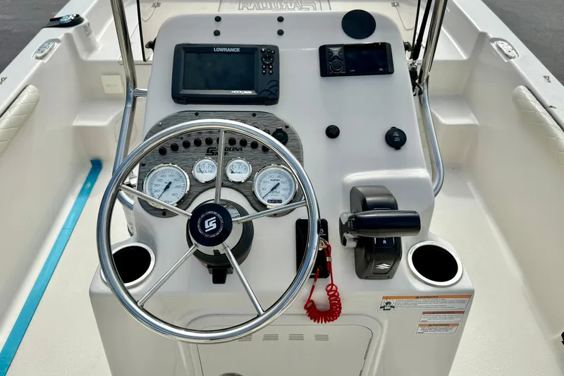 Slide: The Image of 2024 Carolina Skiff 19 LS boat console with steering wheel and navigation instruments. - 3
