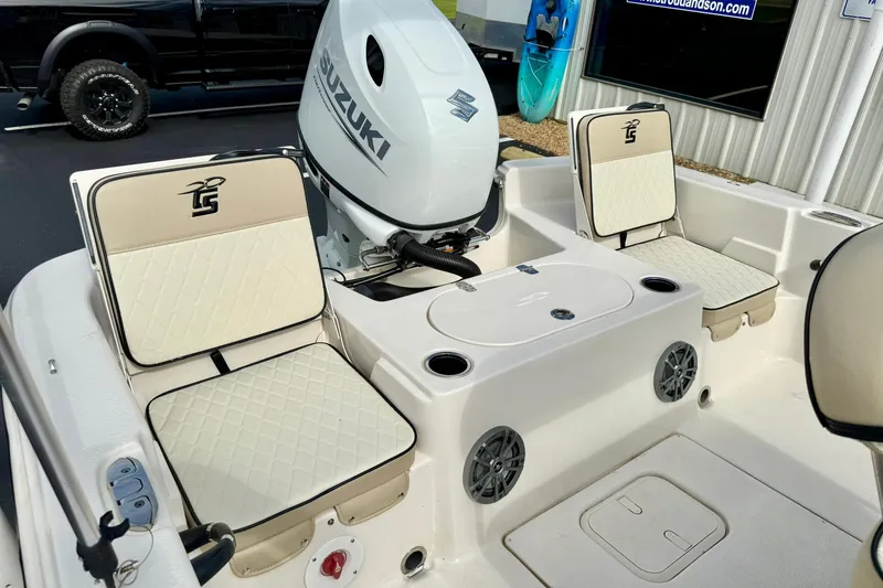 Slide: The Image of 2024 Carolina Skiff 19 LS boat interior with Suzuki engine and cushioned seating. - 30