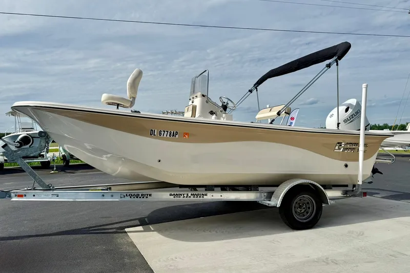 Slide: The Image of 2024 Carolina Skiff 19 LS boat on trailer, parked outdoors under cloudy sky. - 5