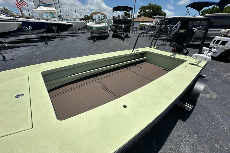 Slide: The Image of Sawgrass 17 boat, 2025 model, displayed in a marina with other boats. - 15