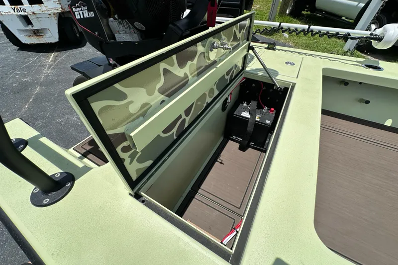 Slide: The Image of Open storage compartment on 2025 Sawgrass 17 boat with camouflage design. - 6