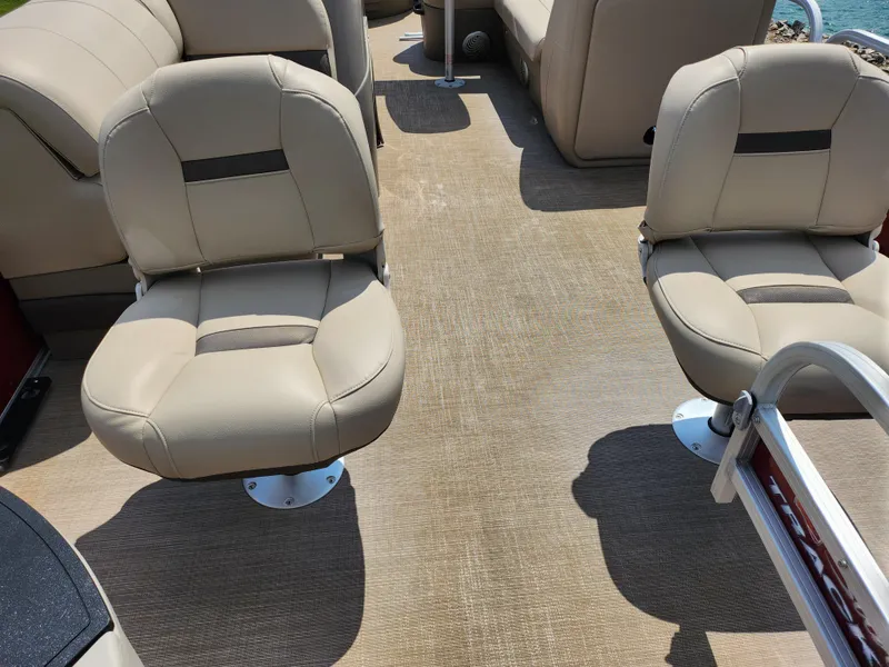 Slide: The Image of 2021 Sun Tracker Fishin' Barge 20 DLX interior with beige seating and carpeted floor. - 10