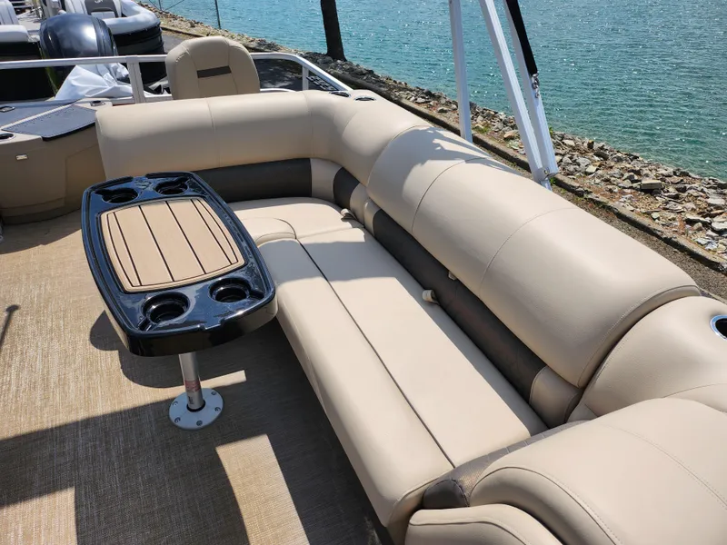 Slide: The Image of 2021 Sun Tracker Fishin' Barge 20 DLX with beige seating and table by the water. - 15