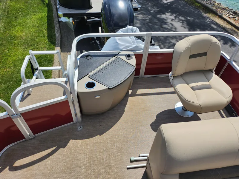 Slide: The Image of 2021 Sun Tracker Fishin' Barge 20 DLX interior with seating and fishing station. - 18