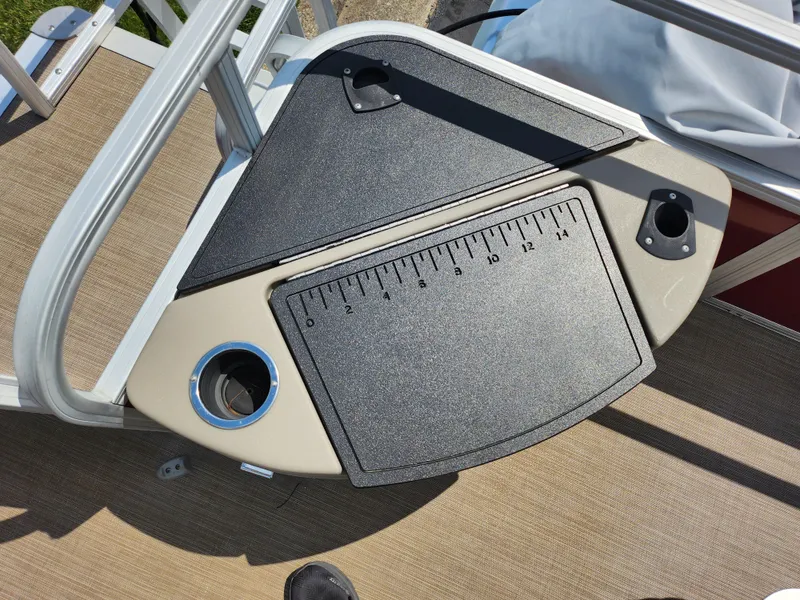 Slide: The Image of 2021 Sun Tracker Fishin' Barge 20 DLX fishing station with measuring board and cup holder. - 20