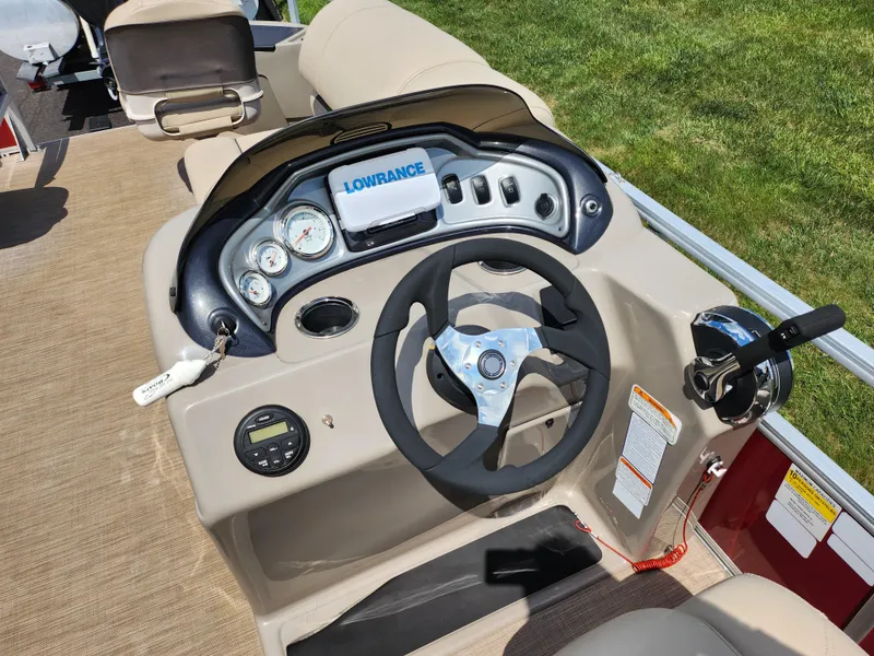 Slide: The Image of 2021 Sun Tracker Fishin' Barge 20 DLX dashboard with steering wheel and control panel. - 25