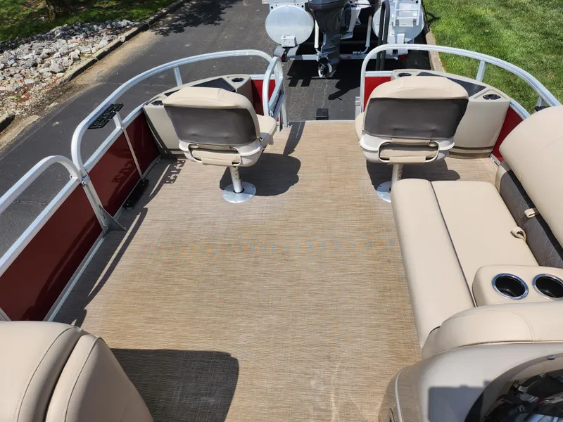 Slide: The Image of 2021 Sun Tracker Fishin' Barge 20 DLX interior with beige seating and cup holders. - 28