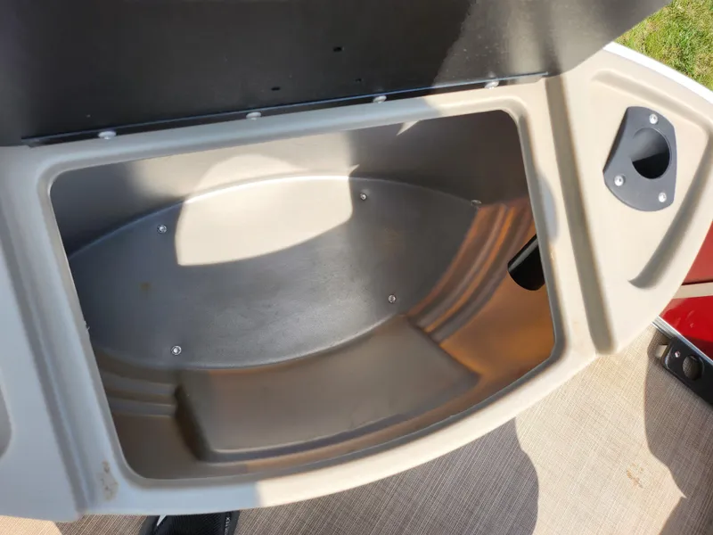 Slide: The Image of Open storage compartment on a 2021 Sun Tracker Fishin' Barge 20 DLX boat. - 30
