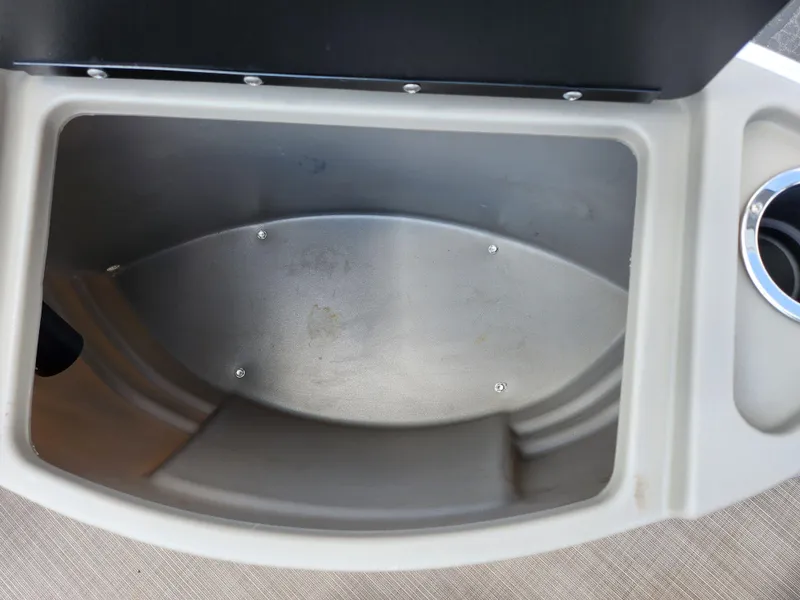 Slide: The Image of Storage compartment of 2021 Sun Tracker Fishin' Barge 20 DLX with cup holder. - 31