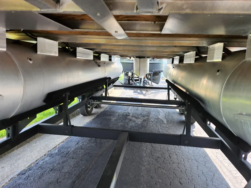 Slide: The Image of Underneath view of a 2021 Sun Tracker Fishin' Barge 20 DLX pontoon boat on a trailer. - 7