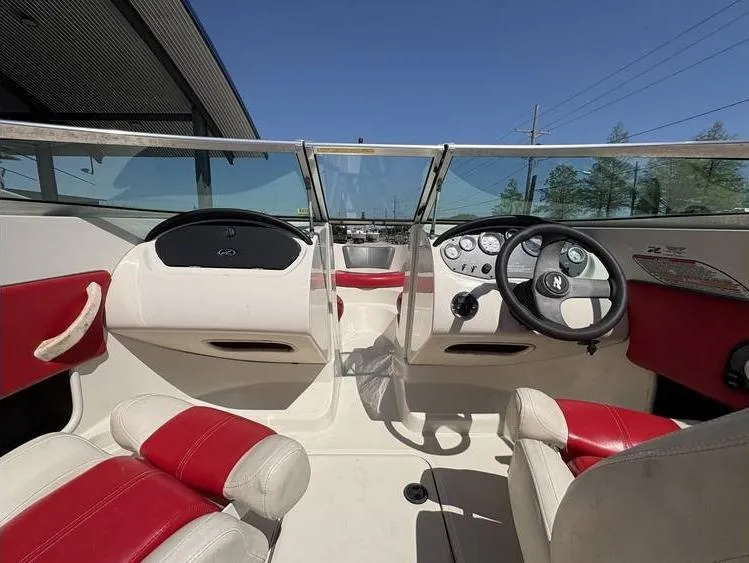 Slide: The Image of 2007 Sea Ray 195 Sport boat interior with red and white seating, steering wheel, and dashboard. - 10