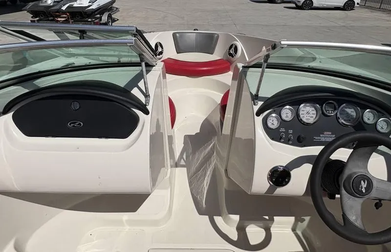 Slide: The Image of 2007 Sea Ray 195 Sport boat interior with red seating and dashboard controls. - 11