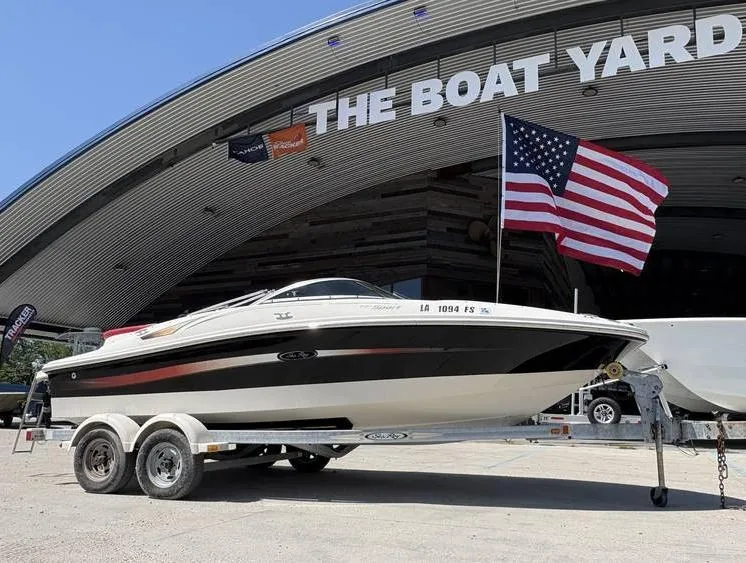 Slide: The Image of 2007 Sea Ray 195 Sport boat on trailer, displayed at The Boat Yard with American flag. - 12