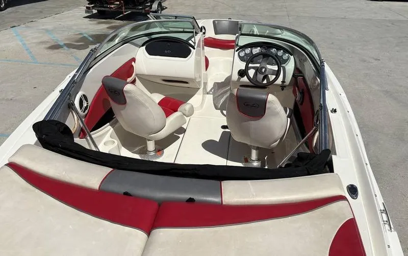 Slide: The Image of 2007 Sea Ray 195 Sport boat interior with red and white seating and steering wheel. - 6