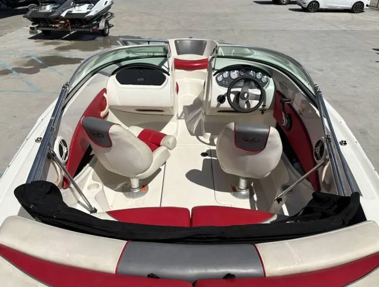 Slide: The Image of 2007 Sea Ray 195 Sport boat interior with red and white seating, steering wheel, and dashboard. - 7